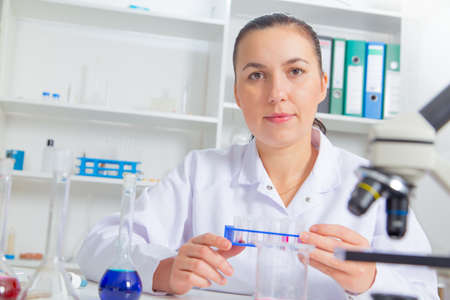 Young female scientist in lab , doing experiments in lab.