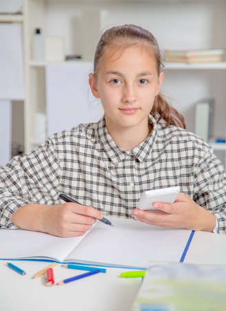 Teenage girl preparing for exams. Teenage girl doing homework for school.の写真素材