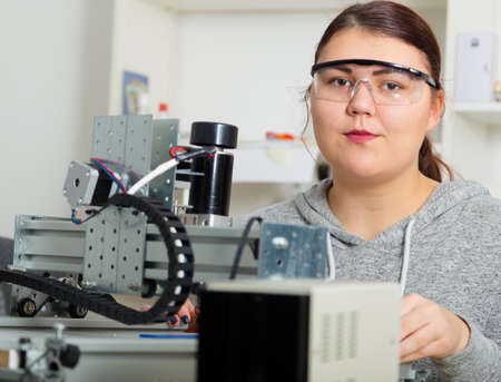 Female Apprentice working  on CNC machinery.の写真素材