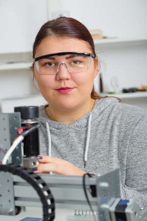 Female Apprentice working on CNC machinery.の写真素材