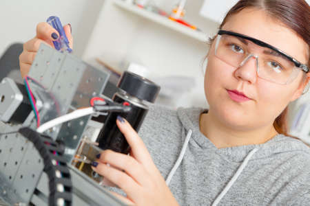Female Apprentice working on CNC machinery.の写真素材