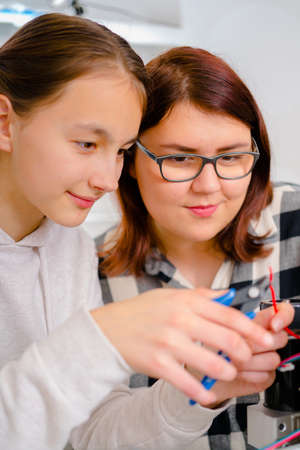 Female Apprentice working  on CNC machinery.の写真素材