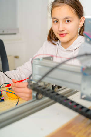 Teen girl working  on CNC  machinery.の写真素材