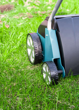 Scarifier on green grass. Work in the garden. scarifier.