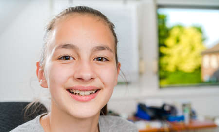 Teenager with braces on her teeth.