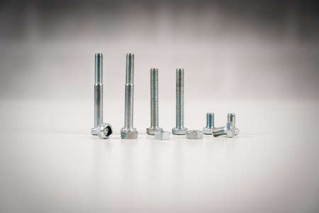 metal screw, bolt and nuts on white background.