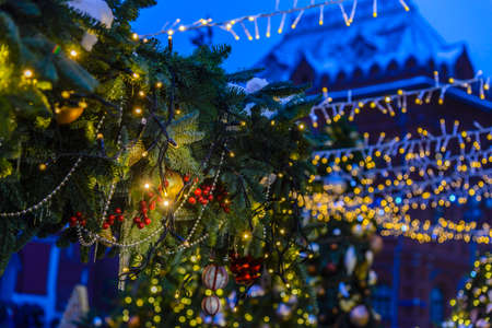 Christmas card with Christmas tree decorations and garlands on the backgroundの写真素材