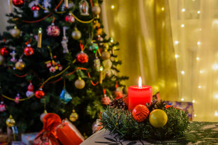 Burning candle and Christmas tree with toys on New Year's Eveの写真素材