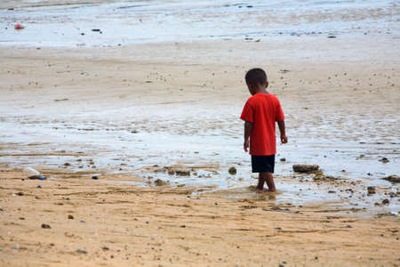 A child walks on a sandy beach. Pattaya. Thailand.の写真素材