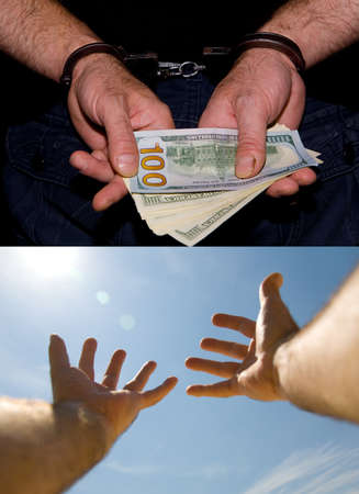 Male hands in handcuffs with money and free - without money.の写真素材