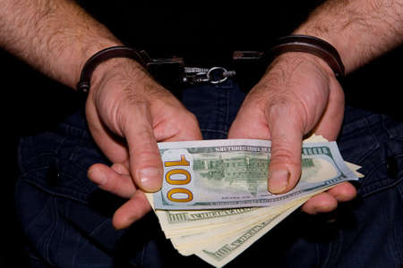Money bills in male hands on that handcuffed.