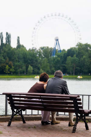 Moscow, Russia, July 28, 2013: Vacationers. A man and a woman at an age are sitting on a park bench.のeditorial素材