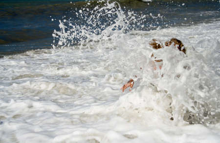 Element. A large wave covered the girl in the sea.