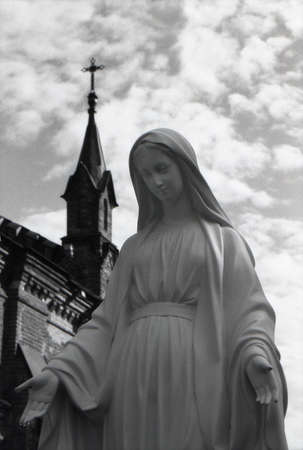 Vladimir, Russia, July 26, 2013: Holy Virgin Mary with drops of clean rain water on her fingers against the background of the cross on the dome of the Catholic church. Temple of St. The Rosary. Attention! The image contains the graininess of the photograpのeditorial素材