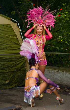 Moscow, Russia. July 28, 2013: Girls in beautiful outfits with feathers are preparing for the...