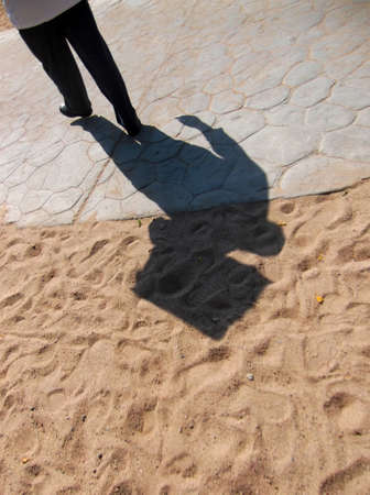 Shadow of the waiter with a tray outside.