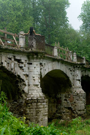 Moscow, Russia, May 16, 2010: On the beautiful old bridge there is a slender girl. Russia.のeditorial素材