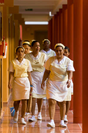 Punta Cana, Dominican Republic, December 12, 2014: The maids in the uniform follow the corridor.のeditorial素材