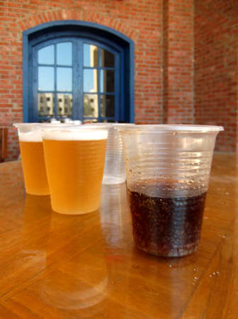 Cocktail with whiskey and beer in cheap plastic cups. Still life.の写真素材