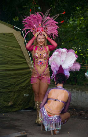 Moscow, Russia. July 28, 2013: Girls in beautiful outfits with feathers are preparing for the performance. Izmailovsky Park.のeditorial素材