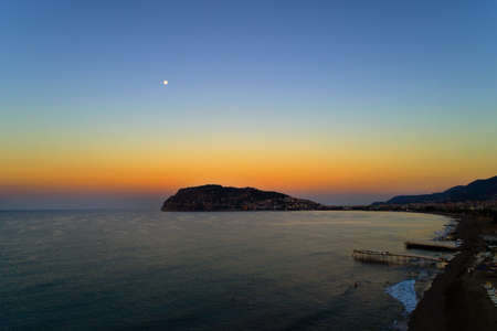 Turkish Alanya. Fortress Selcuk at sunset on a full moon.の写真素材