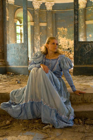A girl in a medieval dress sits on the steps. The Chernyshev Estate.の写真素材