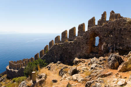 Fragment of the wall of the ancient fortress in Alanya against the background of the sea. Turkey.のeditorial素材