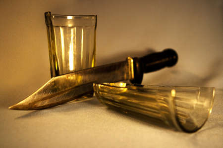 The glass is cut with a knife into two parts. Attention! The image contains granularity!