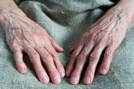 Working wrinkled hands of an old woman. Part of the body.の写真素材