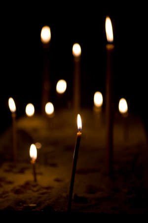 A lot of candles burning in the dark. Still life.の写真素材