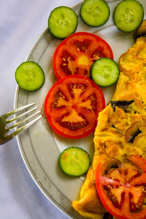 Omelette with mushrooms and vegetables is on the plate. Food.の写真素材