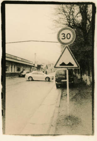 Road sign with added details on the street of Bakuriani village. Scan photos of handmade in retro...