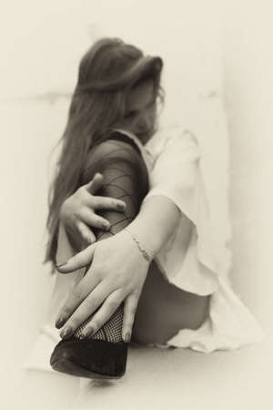 The girl laid her head on her bare knee. Erotica.の写真素材