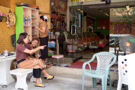 Phuket, Thailand, February 20, 2018: Employees sit at the entrance to the massage parlor and await customers.のeditorial素材