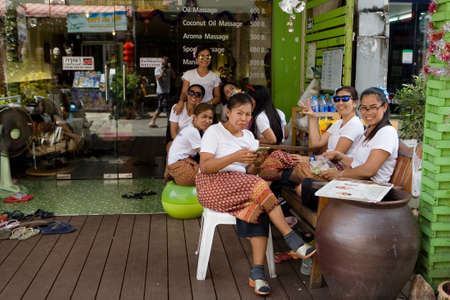 Phuket, Thailand, February 20, 2018: Employees sit at the entrance to the massage parlor and await customers.のeditorial素材