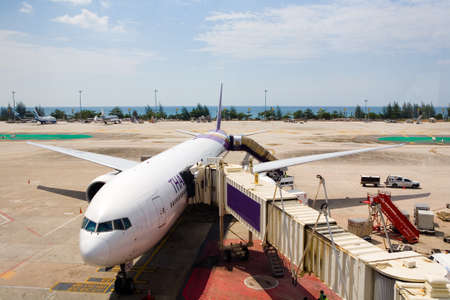 Phuket, Thailand, February 25, 2018: Aircraft of international lines near the arm of the airport.