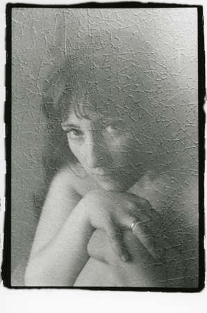 Portrait of a pretty woman with a ring on her finger. Attention! Image contains grit and other...