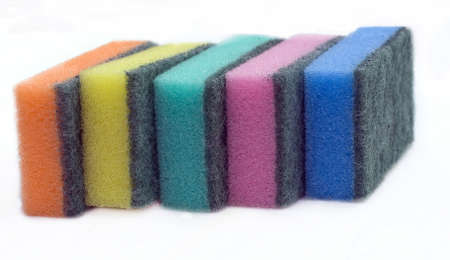 five multi-colored sponges for ware washing on a white background