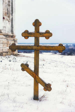 wooden cross on a monastic cemetery in the winterの写真素材