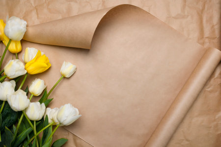 Beautiful postcard with space for copy, tulips white and yellow. Spring blooming tulips on a beige...
