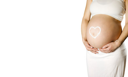 Pregnant woman isolated on white background with space for copy. Draw a heart on the belly of a...