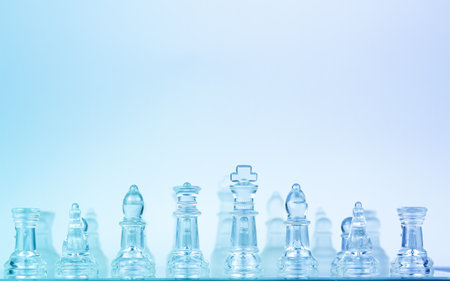 Glass chess in a row on a blue background with space for a copy. Glass chessmen glitter with blue background Chess piece, Glass -material, Chessboard, Chessboard, Plexiglasの写真素材