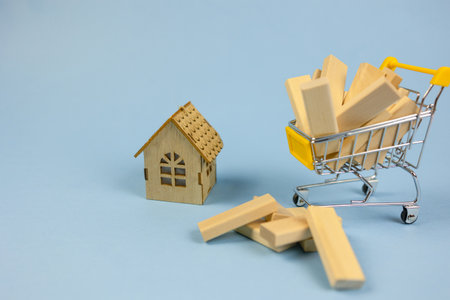 Conceptual photography, construction, wooden house, light wood bars. Advertising concept banner, construction companies, psychology of life, space for copy, text and advertisingの写真素材