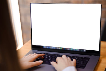 Womens hands type on the keyboard close-up with space for copy. A white laptop screen with space for text and advertising. Work on a laptop, student, businessman, hands of a womanの写真素材