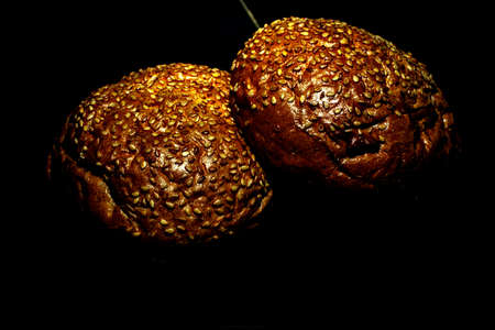 Hamburger bun with cinnamon on a dark backgroundの写真素材