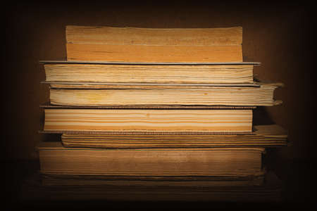 stack of old books on brown backgroundの写真素材