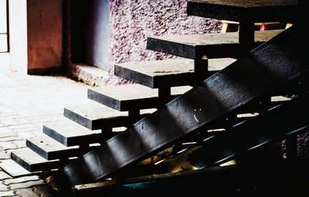 Light and shadow through the steps of the stairsの写真素材