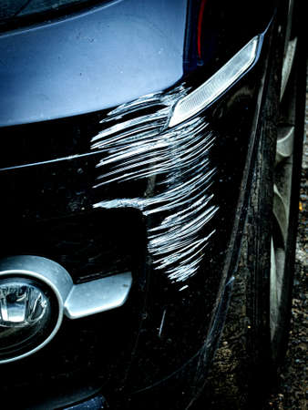 Damage to the bumper of a black carの写真素材
