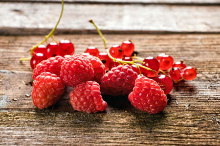 fresh raspberries on wooden backgroundの写真素材
