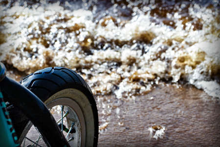 bicycle wheel on the background of the riverの写真素材